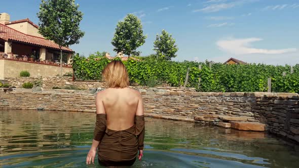 Woman Relaxing the Countryside in Natural Swimming Pool From Stone  Tuscany Italy
