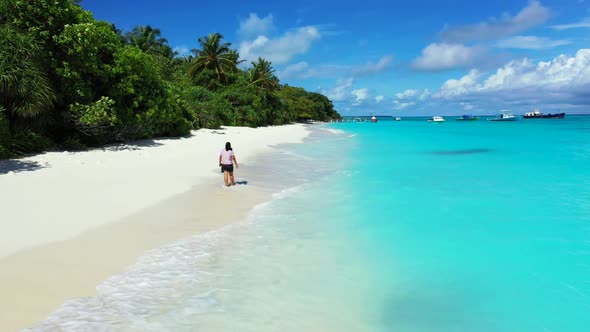 Single female happy and smiling on relaxing bay beach journey by aqua blue ocean with white sandy ba