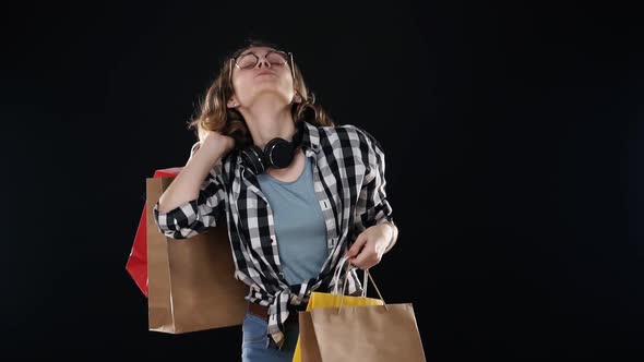 Smiling Excited Buyer Young Modern Woman with Headphones on Neck and Stylish Glasses Posing with