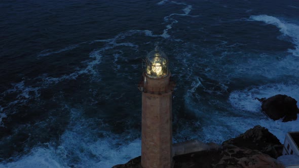 Lit Lighthouse at Dusk in Cape Vilan Galicia Spain Aerial View