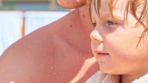 Two Boys Sitting near Swimming Pool