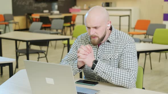 Teacher Who Teaches Online Lessons Sits in Front of the Computer