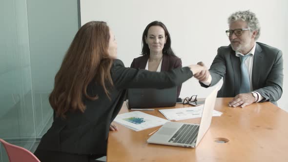 Young Female Manager Shaking Hands with Partners