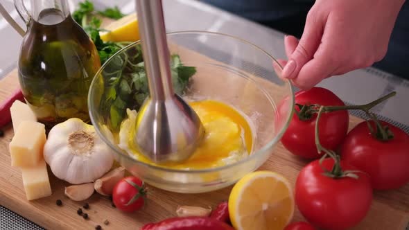 Making Caesar Salad Sauce  Mixing Egg Yolk in Glass Bowl with Blender