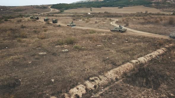 Aerial Shot of Tanks in Columns Setting Off From Military Base