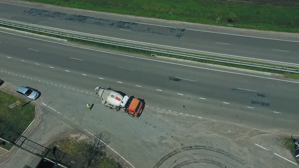 Concrete mixer truck on highway. Aerial view of mixer truck transporting cement to the casting place