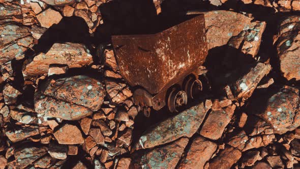 Abandoned Rusty Mine Cart on Rocks alt