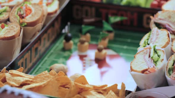 Football Snack Stadium filled with sub sandwiches, veggies and chips.