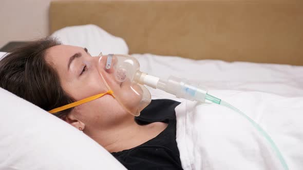 Young Woman with a Face Mask Lying on a White Bed