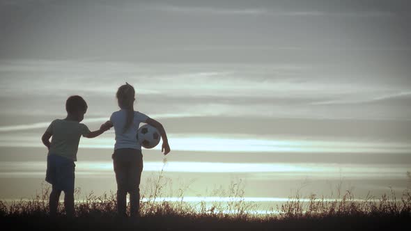 Two Happy Child Playing on Meadow, Sunset, Summertime