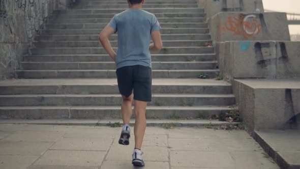 Runner Training Up Stairs Before Competition.Running Man On Step Half Marathon.Runner Man On Stairs