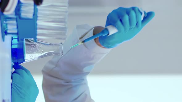 Vertical Video Laboratory Senior Man Scientist Working with Test Tubes and a Pipette