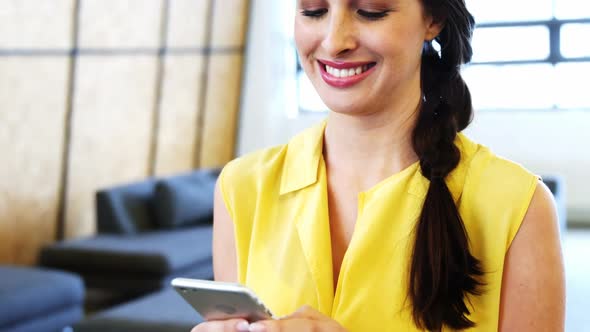 Female business executive using mobile phone