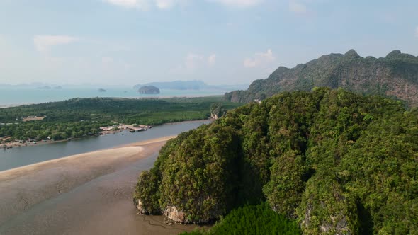 Drone revealing a large sandbar, mangroves and mountains in Ao Thalane Krabi Thailand on a sunny day