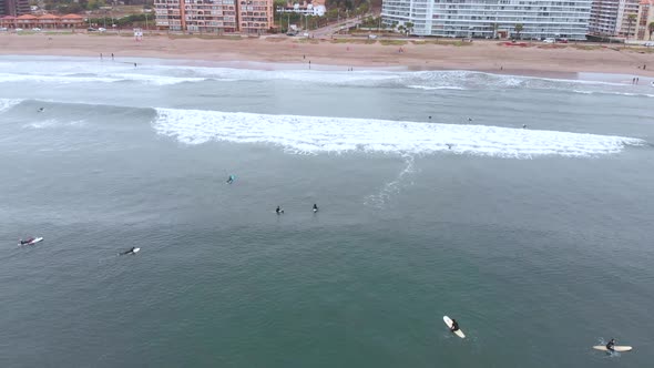 Surfers, Pacific Ocean coast (La Serena, Chile) aerial view, drone footage