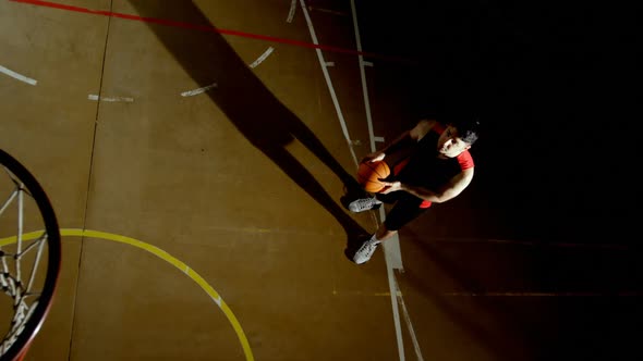 Male basketball player throwing basketball in the basketball hoop 4k