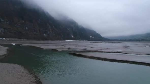 Aerial video of Glaris lake in Switzerland on a cloudy day. 