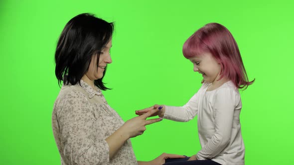 Mother and Little Daughter Playing Rock Paper Scissors. Chroma Key. Leisure Game