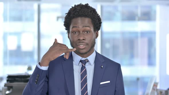 African American Businessman Pointing with Finger and Asking for Call