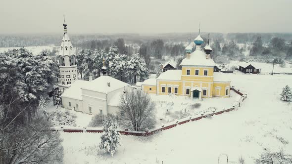 Beautiful Winter Village Landscape with Wooden Houses and a Church Aerial View