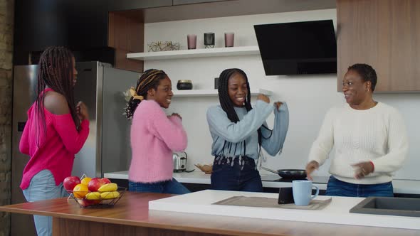 United African Family Dancing Together and Filming on Cellphone