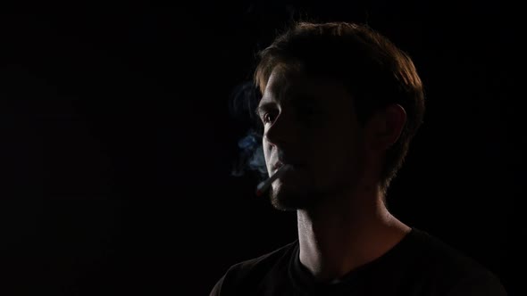 Man Lighting Cigarette. Black. Close Up