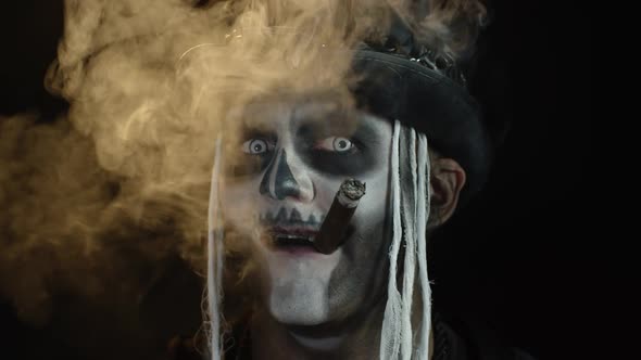 Sinister Man with Horrible Halloween Skeleton Makeup Smoking Cigar, Making Faces, Smiling, Laughing