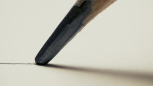 Graphite Pencil Draws a Straight Line on a White Background Paper, Macro Shot