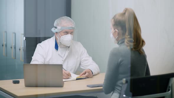 Modern Private Clinic Young Female at a Doctor's Appointment Adult Man Doctor and a Young Woman in