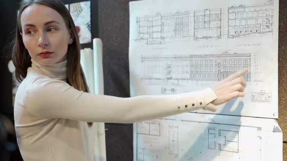 Female Architect Shows a Cottage Construction Project