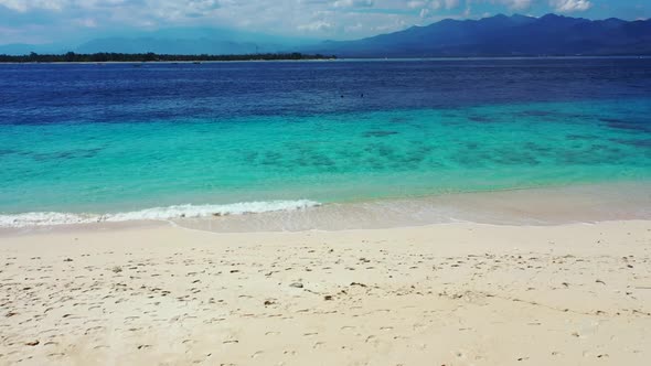 Aerial flying over scenery of exotic island beach voyage by blue ocean and white sandy background of