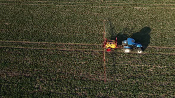 Tractor Spray Fertilizer on Agricultural Field Aerial View