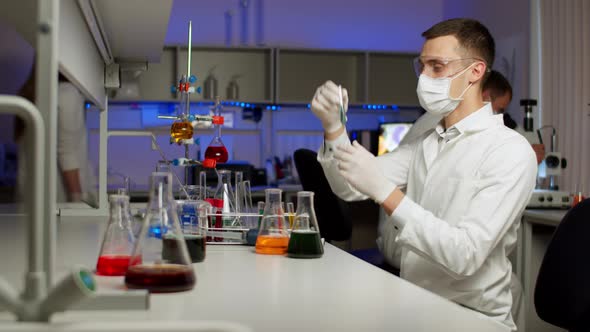 Young Scientist Mixing Colored Liquids