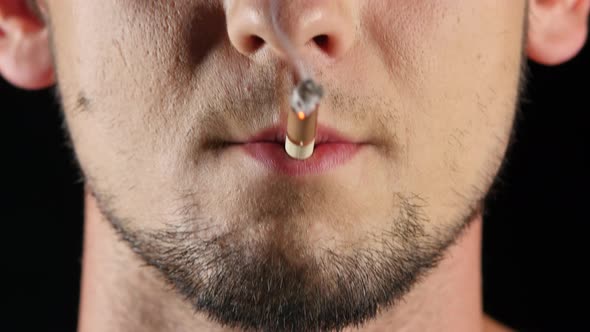 Man Smokes a Cigarette. Bad Habits. Black. Close Up