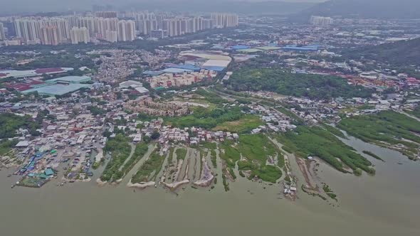 A dynamic birdseye aerial footage of the fishing village in Lau Fau Shan in the New Territories of H