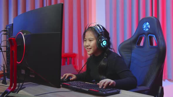 Young Gamer Lady Kids In The Colorful Room Playing Game While She Is Wearing Headphones