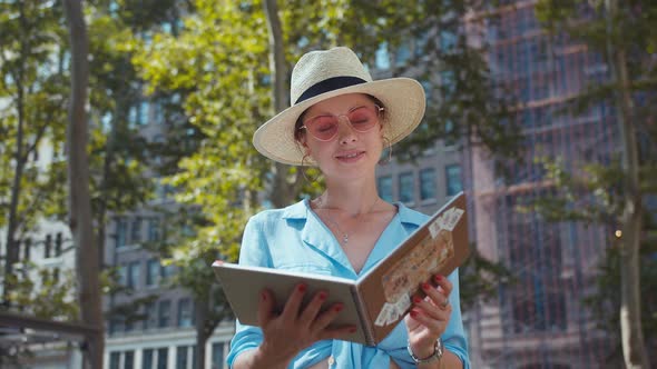 Attractive woman with a travel book