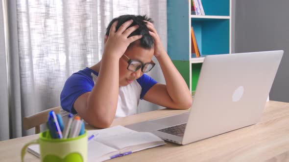 Asian Boy Upset While Using Computer