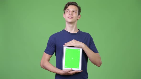 Young Handsome Teenage Boy Showing Digital Tablet