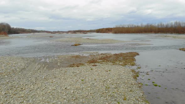 Low Flying Drone Over the River with Rocks