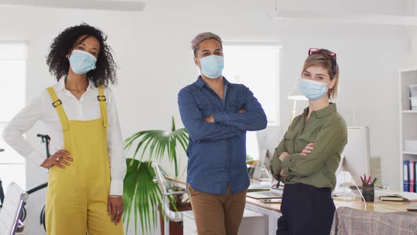 Office colleagues wearing face masks standing in office