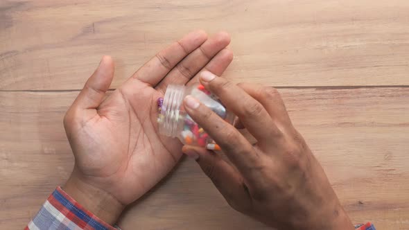 High Angle View of Man Hand Taking Medicine 