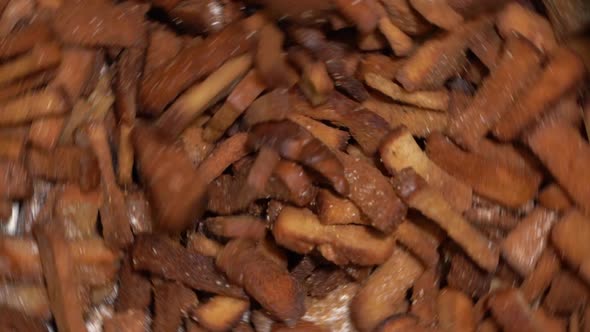 Cooking Crackers. Mixing in a Centrifuge Crackers with Garlic (Taste). Slow Motion