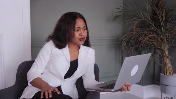 Smiling African American Business Woman Use Laptop Talk on Video Call with Partner or Client