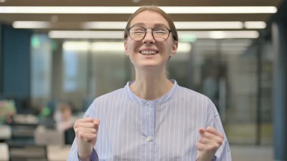 Portrait of Excited Young Woman Celebrating Success