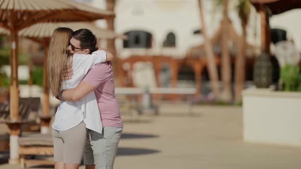 Embrace and Kiss of Loving Couple in Beach of Hotel in Summer