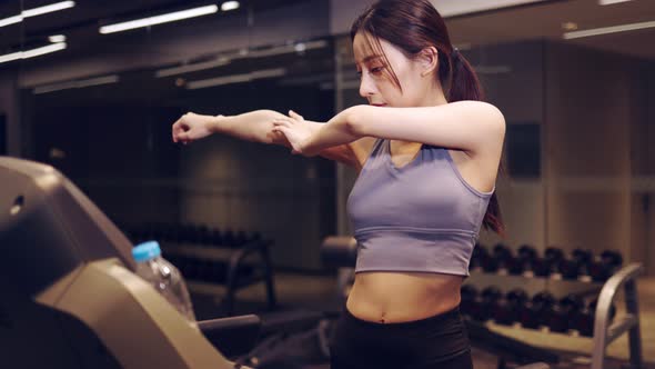 Young beautiful asian woman running on a treadmill at gym. Fitness