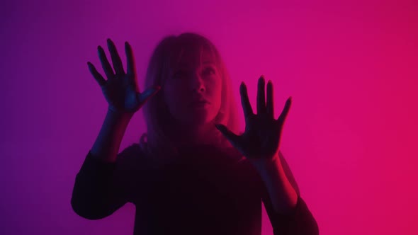 Woman Emerges From Smoke and Touches Glass with Palms