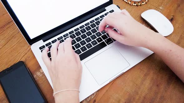 Person typing on notebook keyboard.