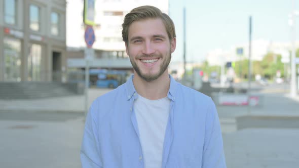 Portrait of Man Smiling at Camera Outdoor